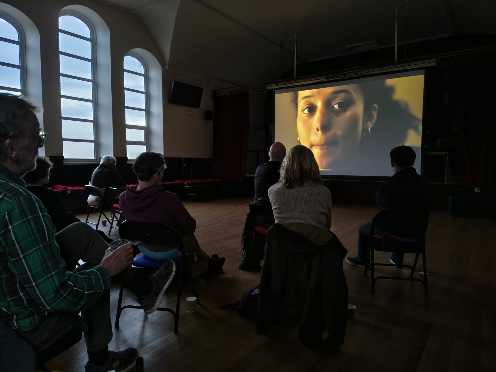 An audience watching a film in the Victoria Diamond Jubilee Hall